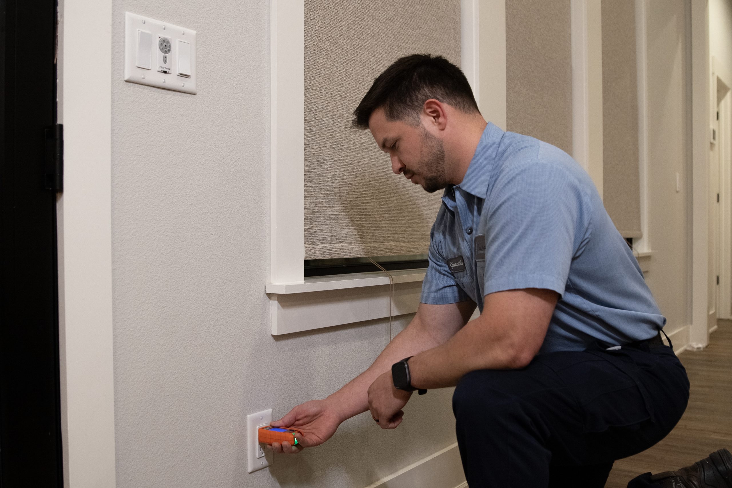 Licensed Paschal electrician testing an outlet with a calibrated meter