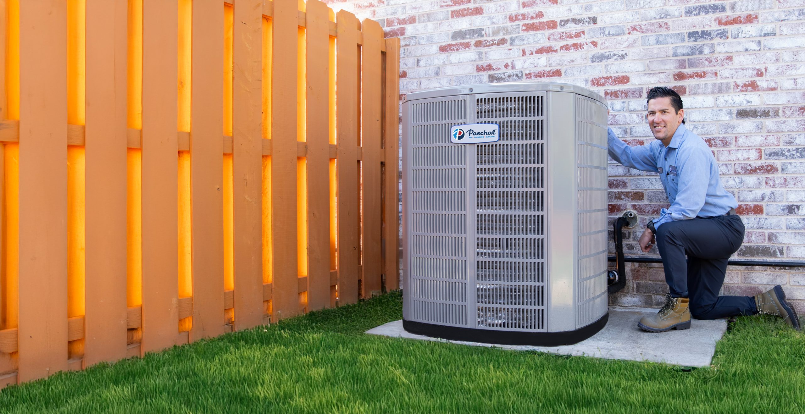 Licensed Paschal HVAC technician at an outdoor unit