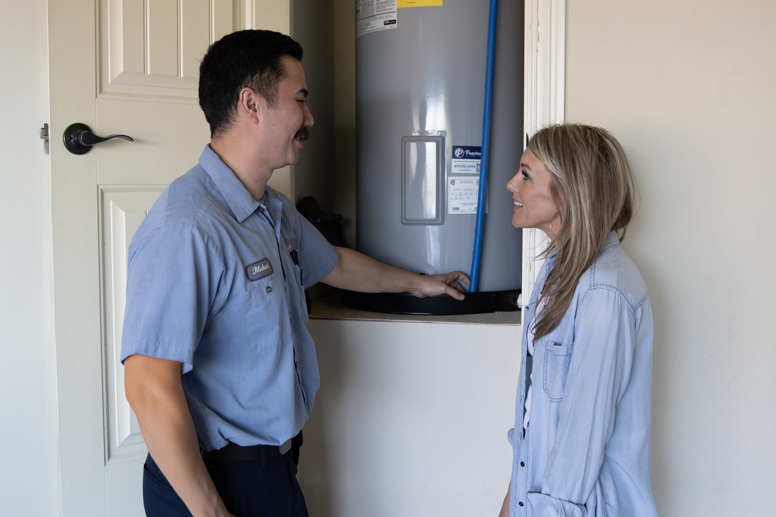 Plumber inspecting a residential water heater