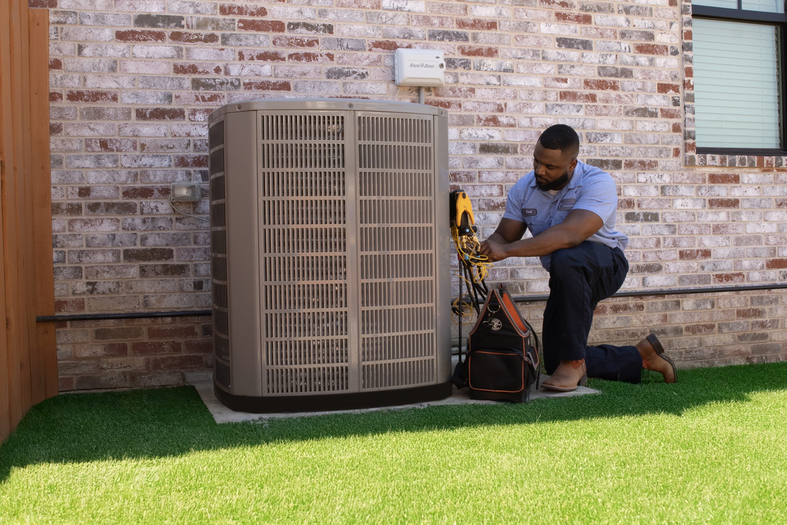 HVAC technician running full AC diagnostic with meters